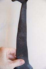 A close-up view of the vintage giraffe's aged and textured dark patina.