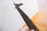 Close-up of the vintage African giraffe's sculpted head and textured, dark patina.