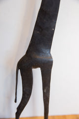 Dark, hand-carved texture on the body and upper legs of the vintage giraffe.