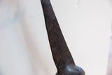 Detailed texture of the dark wood patina and carved spots on the vintage giraffe.