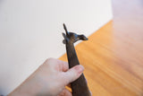 Head of a vintage handmade African giraffe, showing its stylized form and dark surface patina.