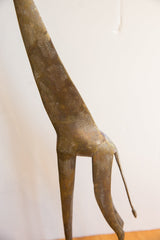 Hand-etched patterns and aged patina on the brass body of the vintage giraffe.
