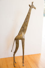 Standing vintage African giraffe collectible, showing its slender form and textured patina.