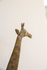 Angled close-up of a vintage African giraffe head, detailing its sculpted form and aged patina.