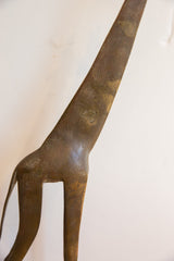 Etched crosshatch details on the aged brown patina of the vintage giraffe sculpture.