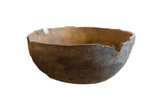Vintage African wooden bowl with rustic dark brown wood and natural aged imperfections.