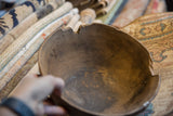 Vintage African wooden bowl interior, showcasing aged dark wood grain and texture.