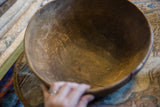 The character-rich interior of a vintage African bowl showing its aged cracks and wear.