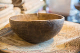 Side profile of the vintage African bowl highlighting its rustic patina and hand-formed shape.