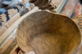 Vintage African wooden bowl interior, showcasing natural wood grain and visible imperfections.