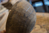 Aged African wooden bowl detail: crack and metal wire repairs.