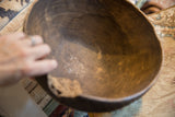 Interior view of the handmade African bowl showing its aged, textured wood surface.