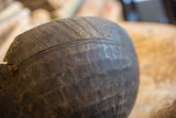 Close-up of the vintage wooden bowl's hand-carved rim and aged, chipped texture.