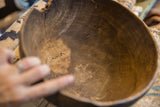 Close-up showing the aged cracks and rich patina inside the wooden bowl.