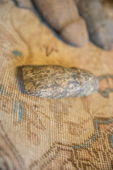 Mottled grey and brown surface showing the aged texture of a primitive stone tool.