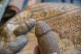 The rough, hand-carved shape and weathered texture of a primitive stone tool.