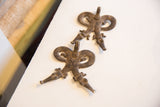 Two vintage African double crocodile pendants displayed together from an angle.