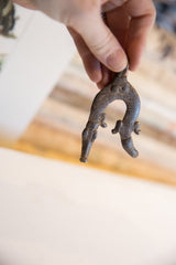 Textured scales and dark metal patina on a vintage African crocodile pendant.