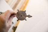 Vintage African turtle pendant with a concentric circle shell held in hand.