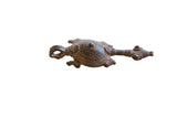 Vintage African turtle pendant in aged metal with a concentric circle shell design.