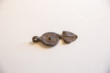 Profile view of the vintage snake pendant showing its textured dark metal finish.