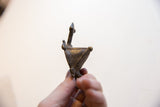 Profile view of the vintage turtle pendant showing its triangular body and stylized neck.