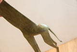 Close-up of the aged patina and textured finish on the vintage giraffe's back and tail.