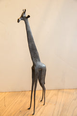Full side view of the tall vintage African giraffe, highlighting its slender, stylized form.