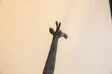 Head detail of the vintage African giraffe sculpture showing its textured, dark finish.