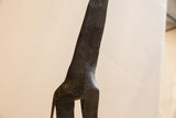 Textured surface detail on the neck and shoulders of the vintage giraffe sculpture.