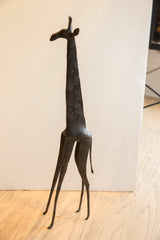 Vintage African giraffe sculpture with a long neck and slender, attenuated legs.
