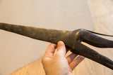 Detailed etched texture and aged dark patina on the vintage African giraffe's body.