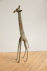 Slender legs and small feet of the vintage African giraffe with aged green patina.