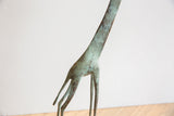 Vintage African giraffe sculpture neck, detailed with mottled green patina and aged texture.