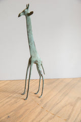 Vintage African giraffe sculpture's long, slender legs with weathered green patina.