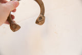 Hand-incised markings on the aged copper terminals of the antique snake cuff.