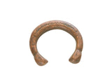 Antique African copper snake cuff bracelet with stamped details and a rich, aged patina.