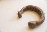 Profile view of the antique copper snake cuff showing its textured patina and opening.
