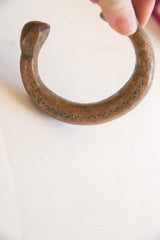 Aged patina and hand-punched details on the antique copper snake cuff.