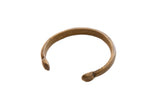 Antique African bronze cuff bracelet with stylized snake head ends and an aged patina.