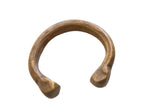 Antique African bronze snake cuff bracelet with a warm patina and etched patterns on its outer curve.
