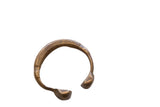 Antique African bronze snake cuff bracelet with carved linear details and a warm patina.