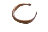 Antique African bronze snake cuff bracelet with a dark, aged patina and incised lines.