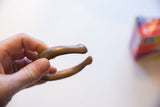 The solid, sculptural form and warm patina of the antique bronze cuff bracelet.