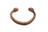 Antique African bronze snake cuff bracelet with a ribbed body and smooth, rounded ends.