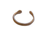 Antique African bronze snake cuff bracelet with an open C-shape and aged patina.