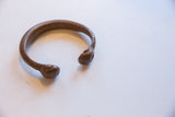 Antique African snake cuff bracelet showing its open form and rich copper patina.