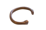 Antique African bronze cuff bracelet featuring a snake pattern and rich, time-worn patina.