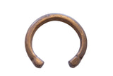 Antique African bronze snake cuff bracelet showing etched geometric details and a warm, aged patina.