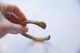 Side view of the antique African bronze cuff showing its curved form.